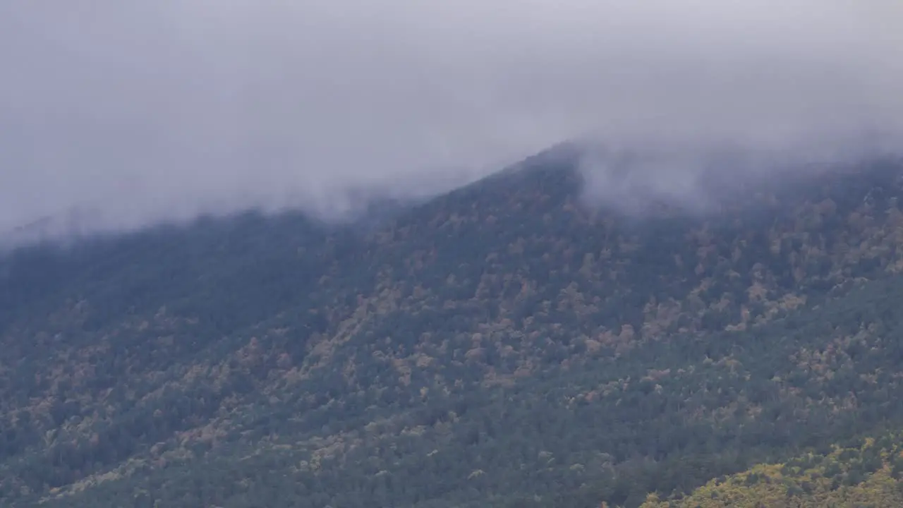 Gray clouds floating over rocky mountain ridge