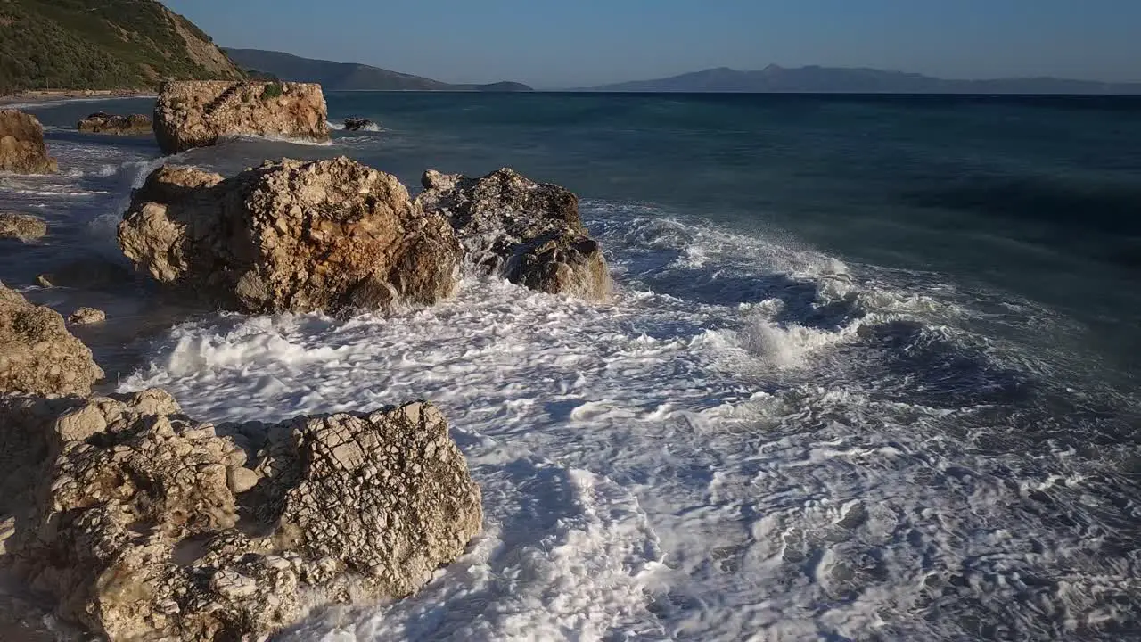 Big waves splashing and foaming on cliffs plunged on beach dramatic sea scene on shoreline of Mediterranean