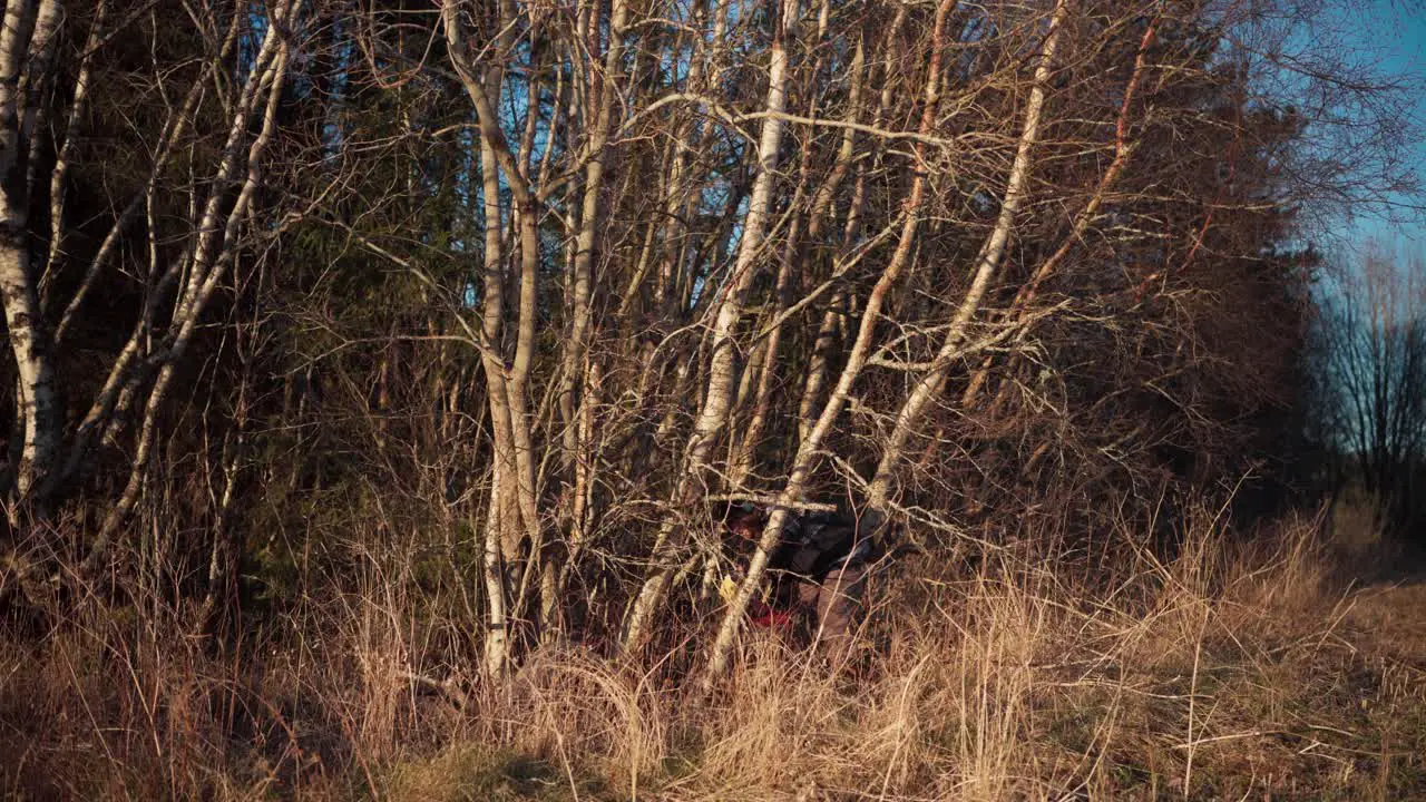 A Man is Employing a Chainsaw to Fell a Tree Static Shot