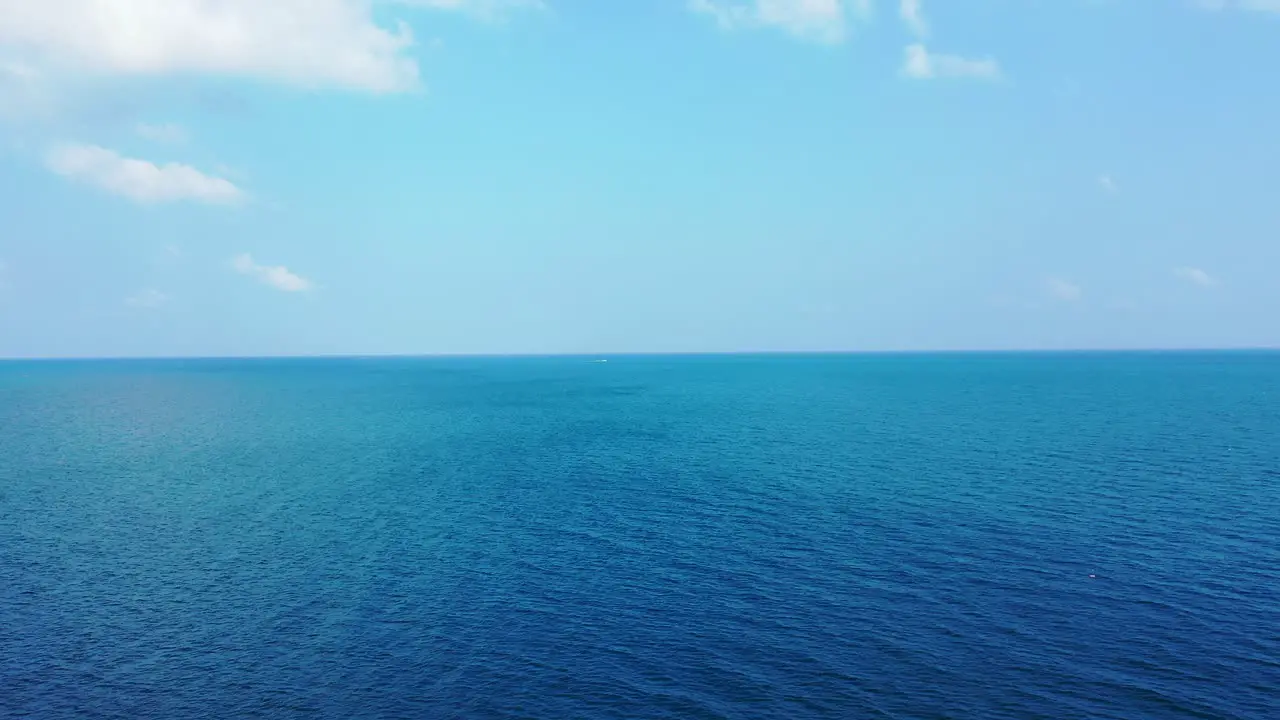 Aerial seascape open blue ocean bright sky with clouds abstract background with copy space