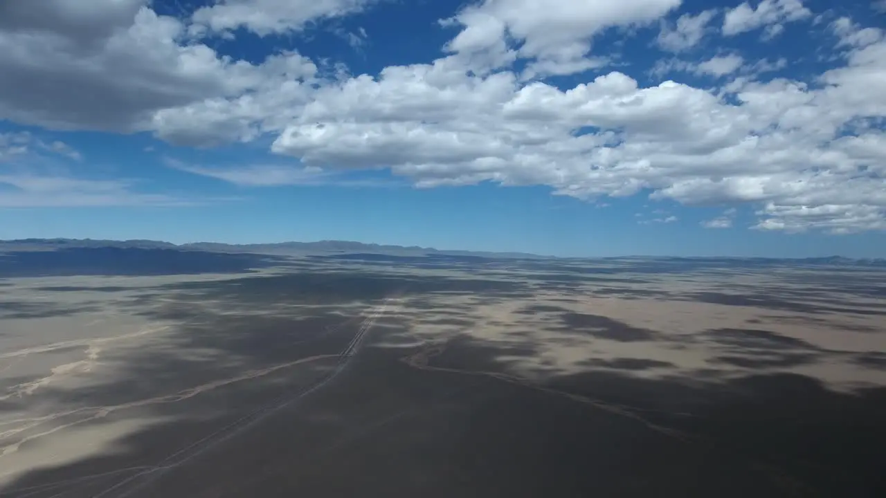 Aerial drone timelapse in desert with clouds and shadows moving on the ground