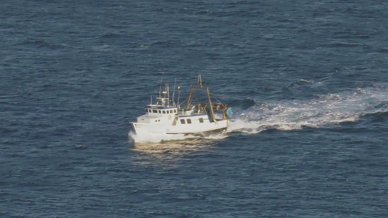 Stern trawler fishing boat on blue sea mediterranean high angle