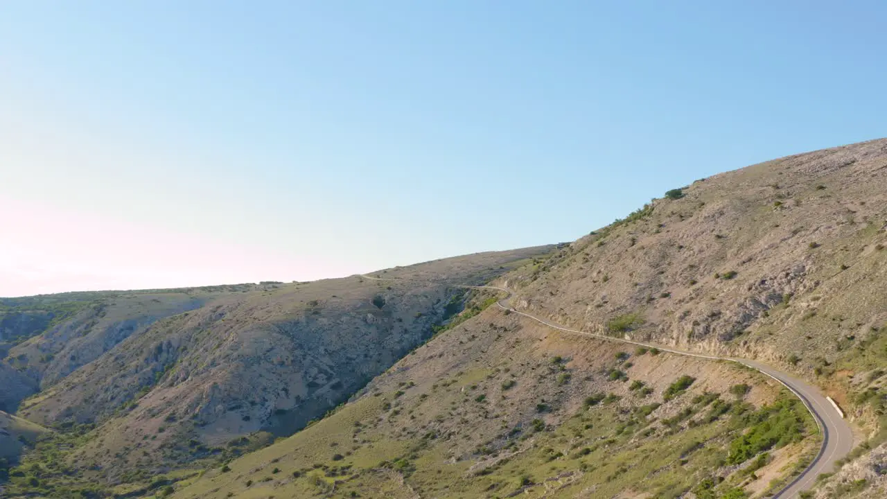 Aerial dolly shot along an isolated mountain road on Krk Island Croatia