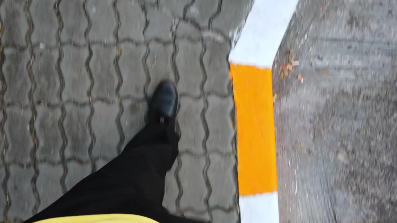 Slowmotion view of the man while walking on the foot-path