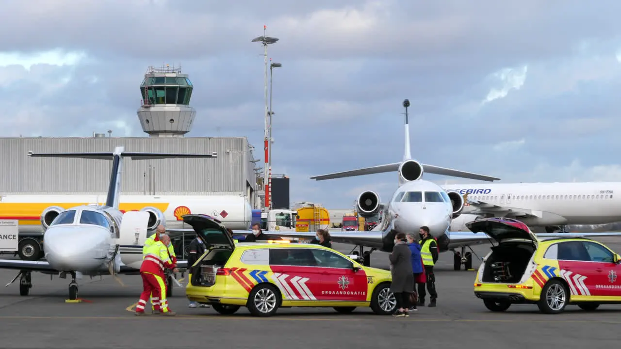 Medical Team At Airport Apron For Jet Airplane Organ Transport