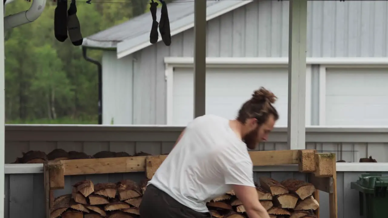 Man Stacked Up Split Logs For Winter Season