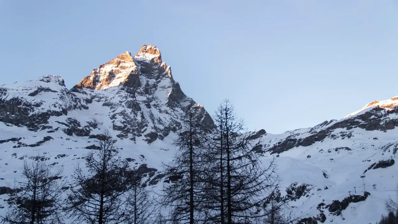 Day to Night timelapse of the Matterhorn as seen from Cervinia Italy on a clear winter night with stars