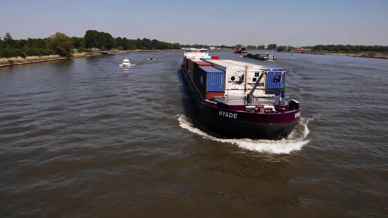 Fully Loaded Container Ship Cruising On The River At Daytime