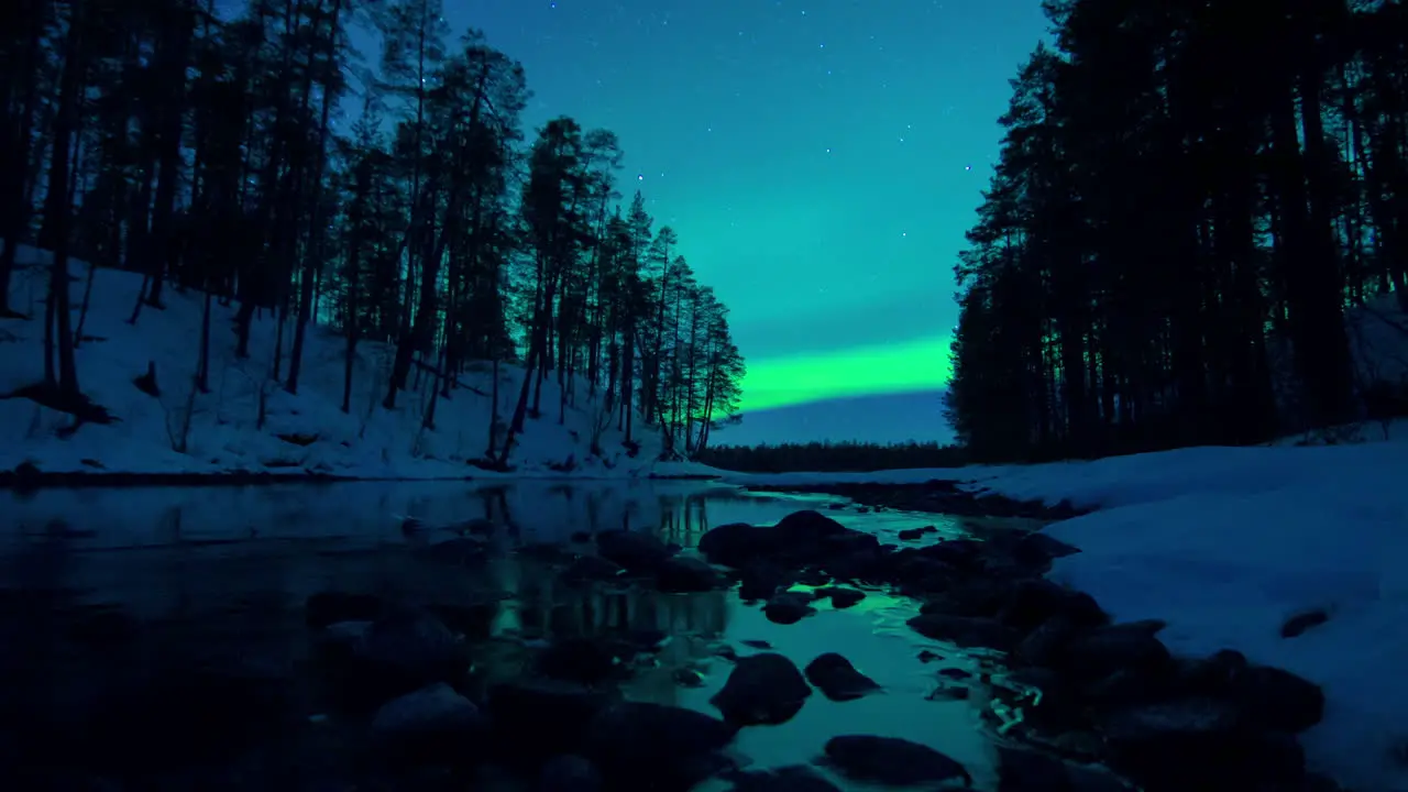 Stunning cinematic day to night motion timelapse of the Aurora over an icy stream