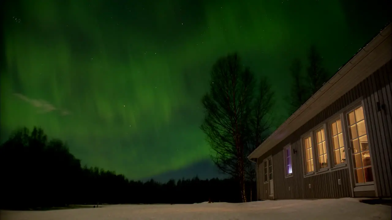 Green Aurora Borealis Polar lights above house in Northern Europe Time lapse