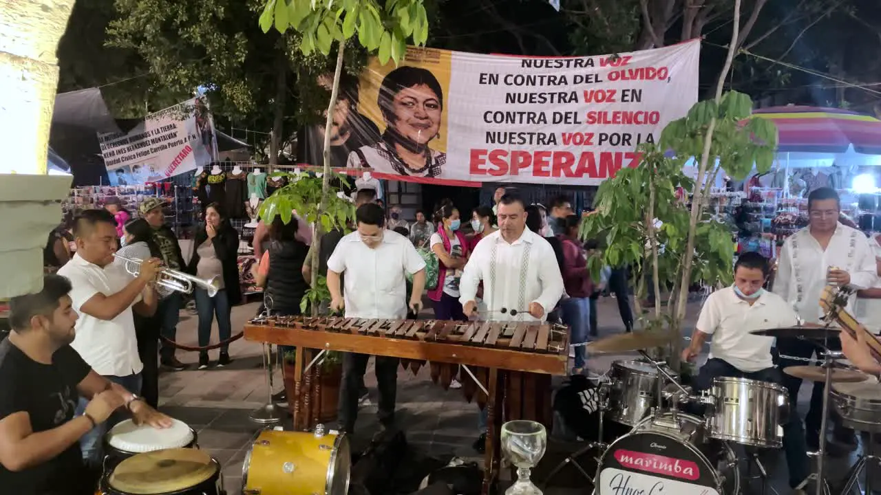 shot of a musical group with marimba in the center of the city of oaxaca