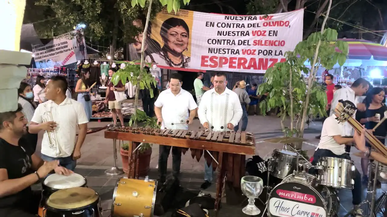 shot of a musical group a in the center of the city of oaxaca