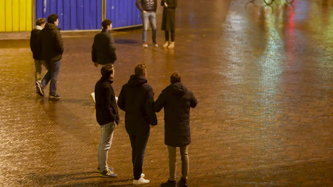 Friends Point at the Grote Markt in Groningen During a Night Out near Entertainment Area