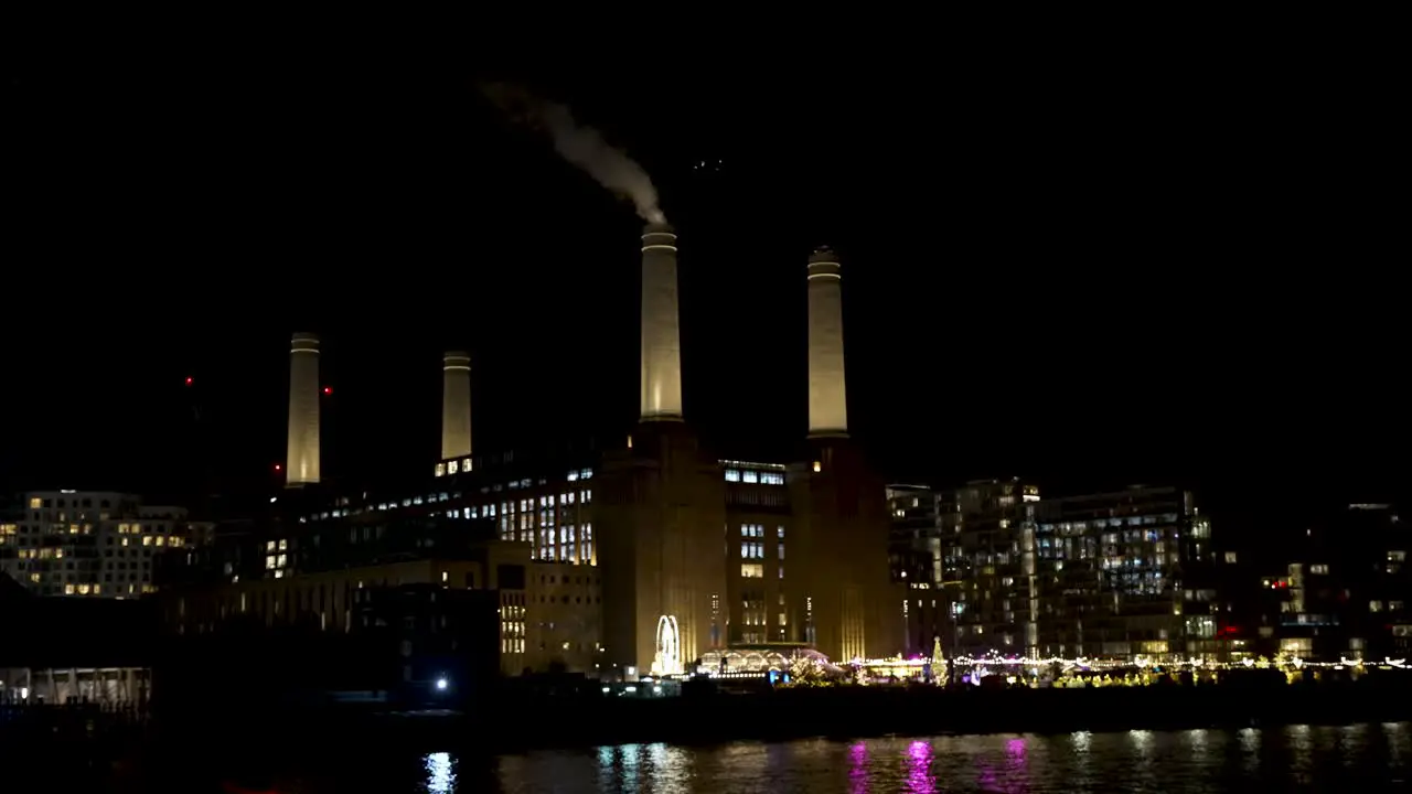 A View At Night Of Battersea Power Station Seen From Grosvenor With Smoke Rising From Chimney Stack