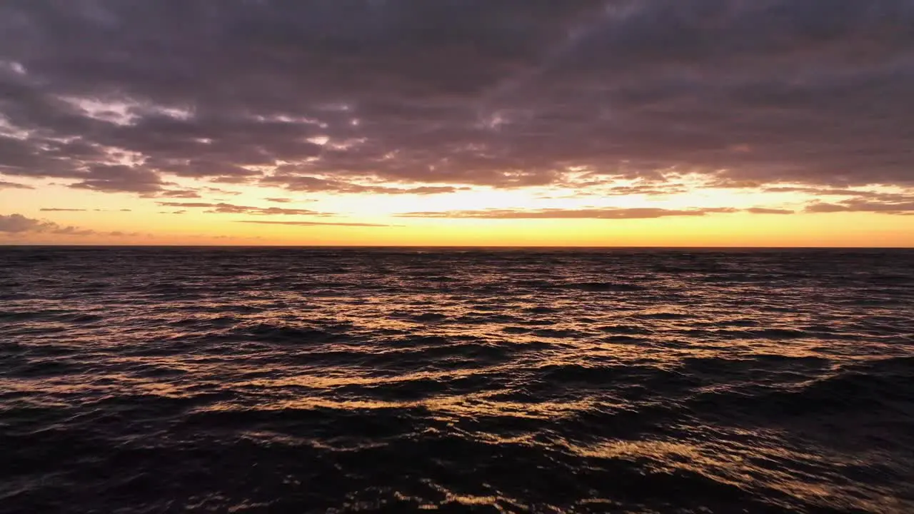 Aerial orange sunrise with sunlight reflection in the sea in Kapaa Kauai