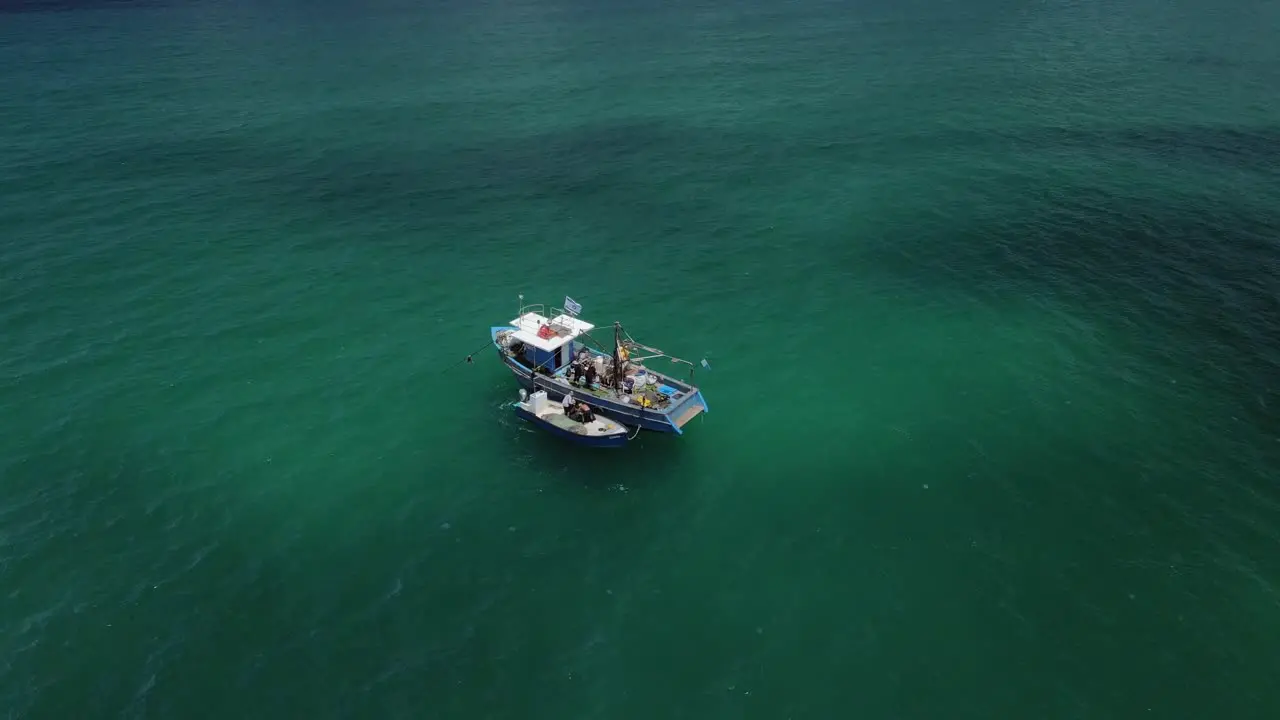 Drone tracking fishing boats in the turquoise colored Haifa bay at Hof Hacarmel in Israel