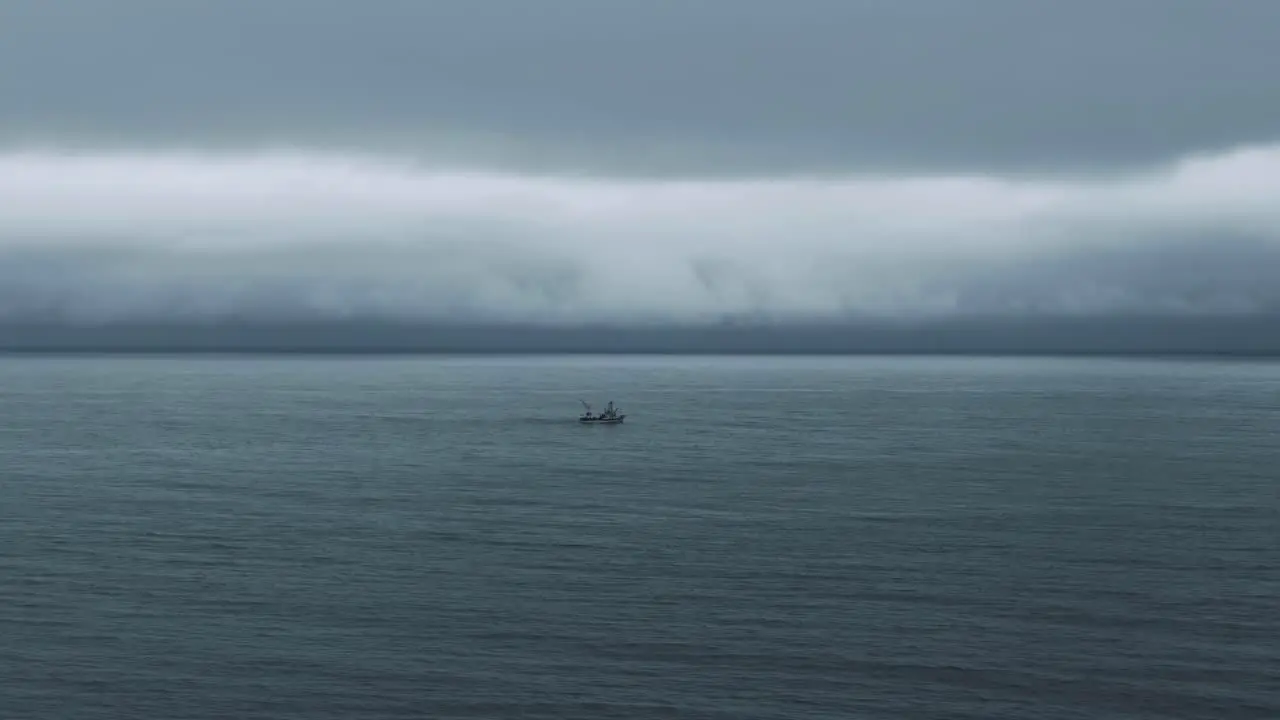 Overflying The Calm Waters Of Saint Lawrence River With A Fishing Boat Sailing In The Distance On A Cloudy Day In Quebec Canada