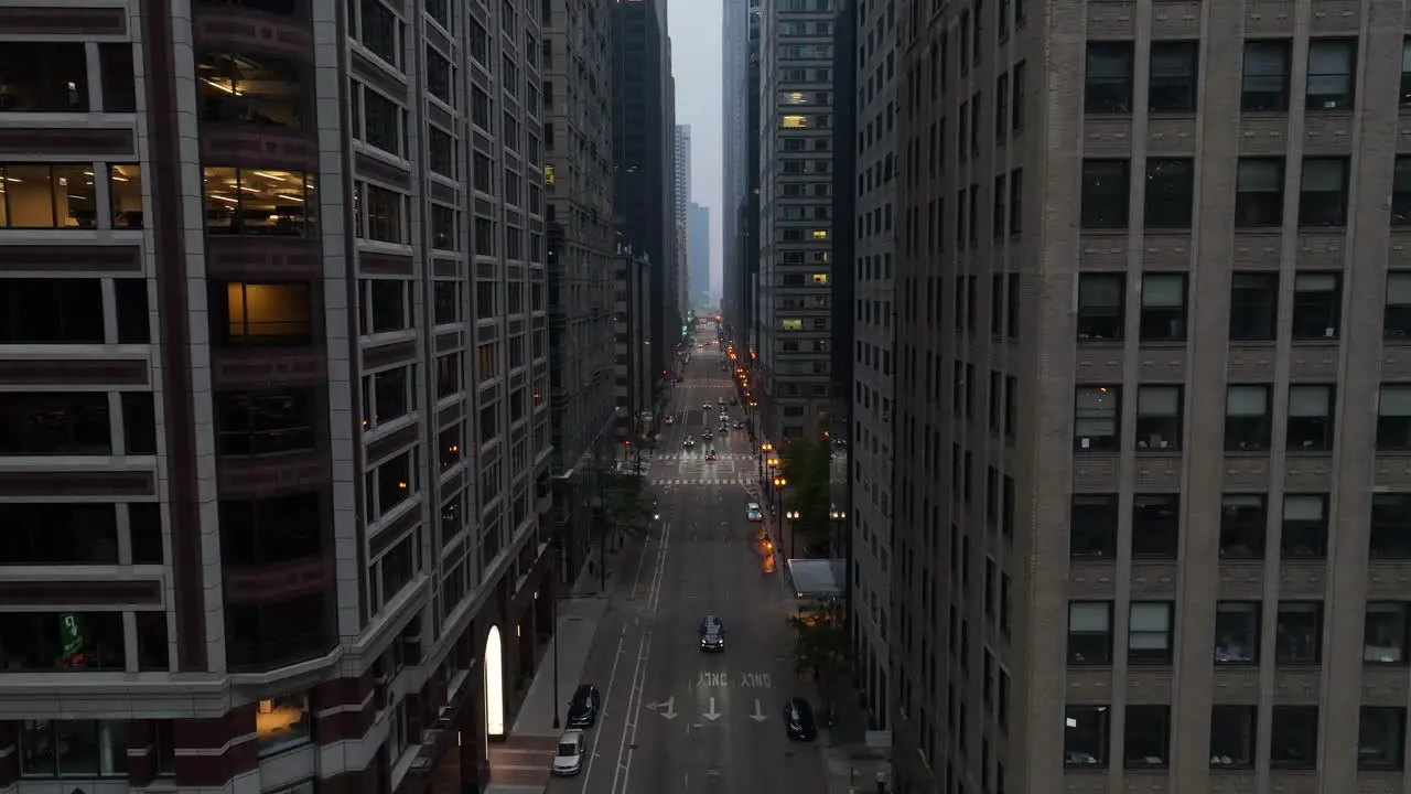 Large city with tall skyscrapers on both sides of downtown street