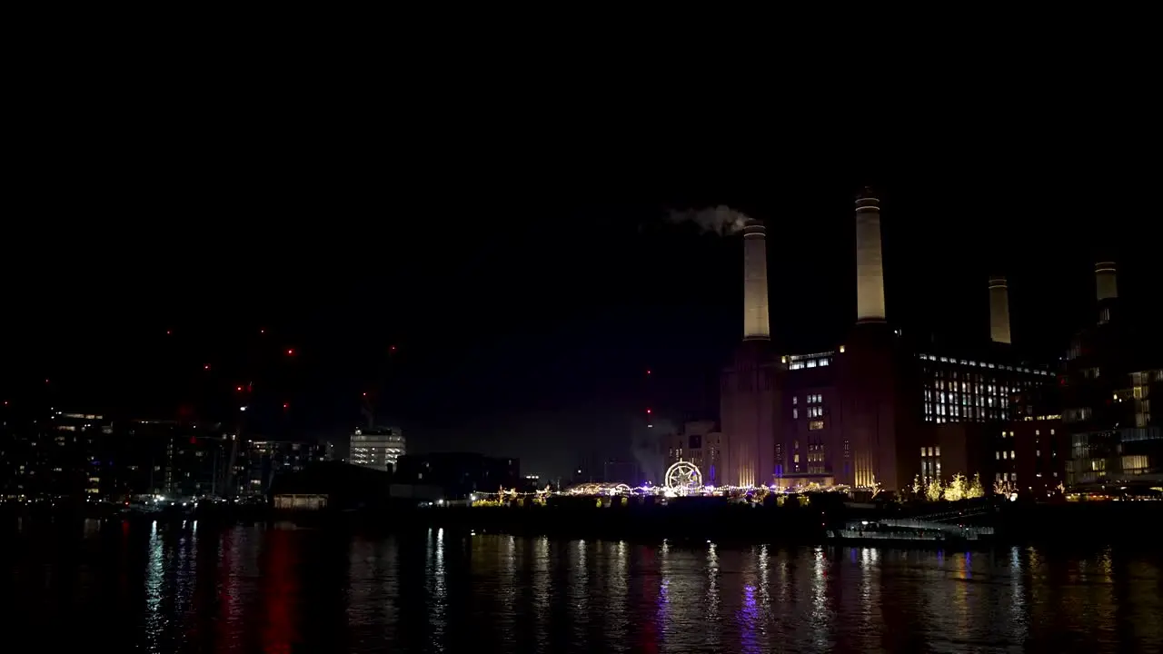 Night View Of Battersea Power Station Seen From Grosvenor With Smoke Rising From Chimney Stack