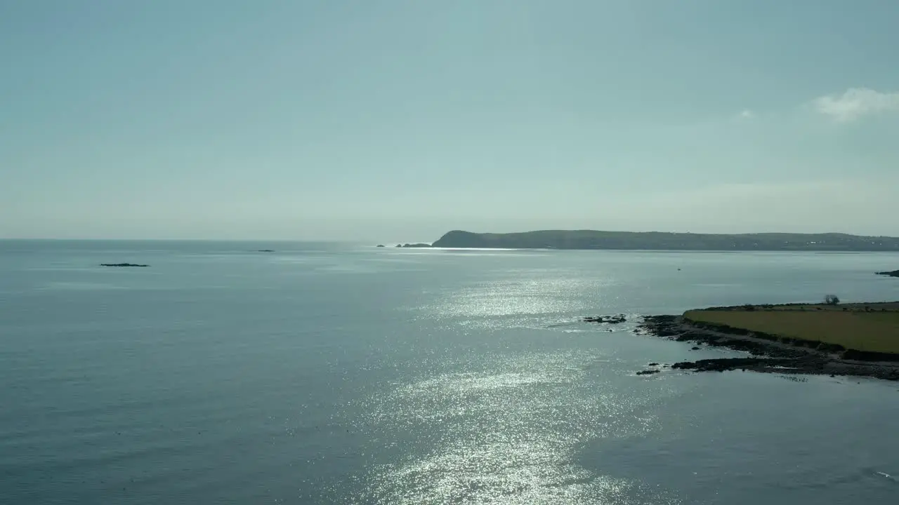 Wide angle dolly in aerial birds eye view of ocean coast during summer day