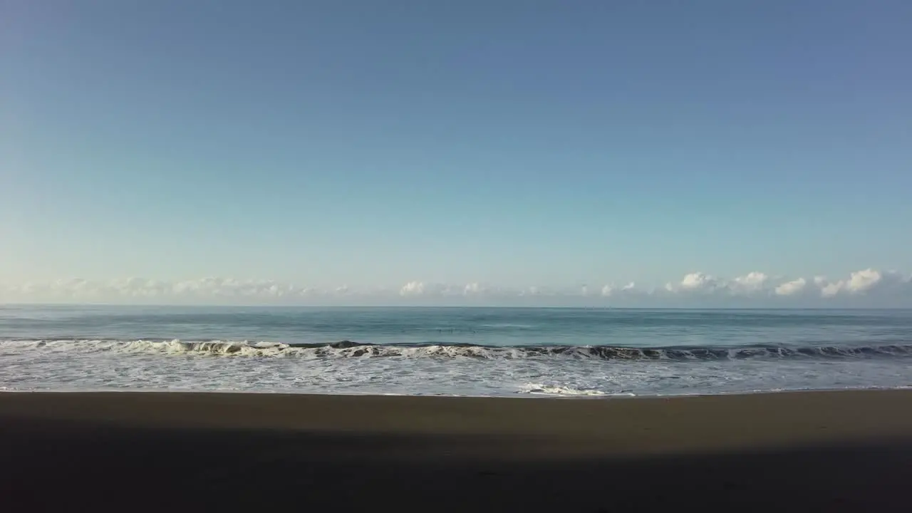 Seagulls passing by over waves crushing in the ocean