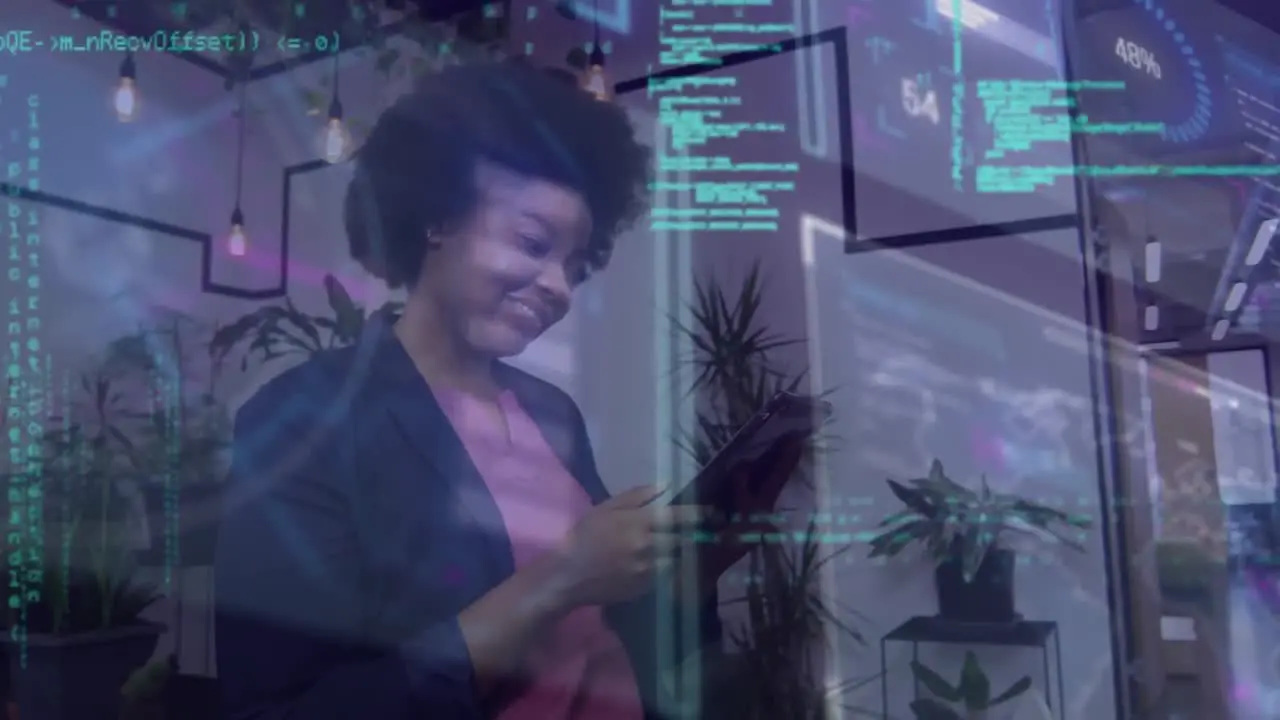 Animation of processing data over smiling african american businesswoman using tablet in office