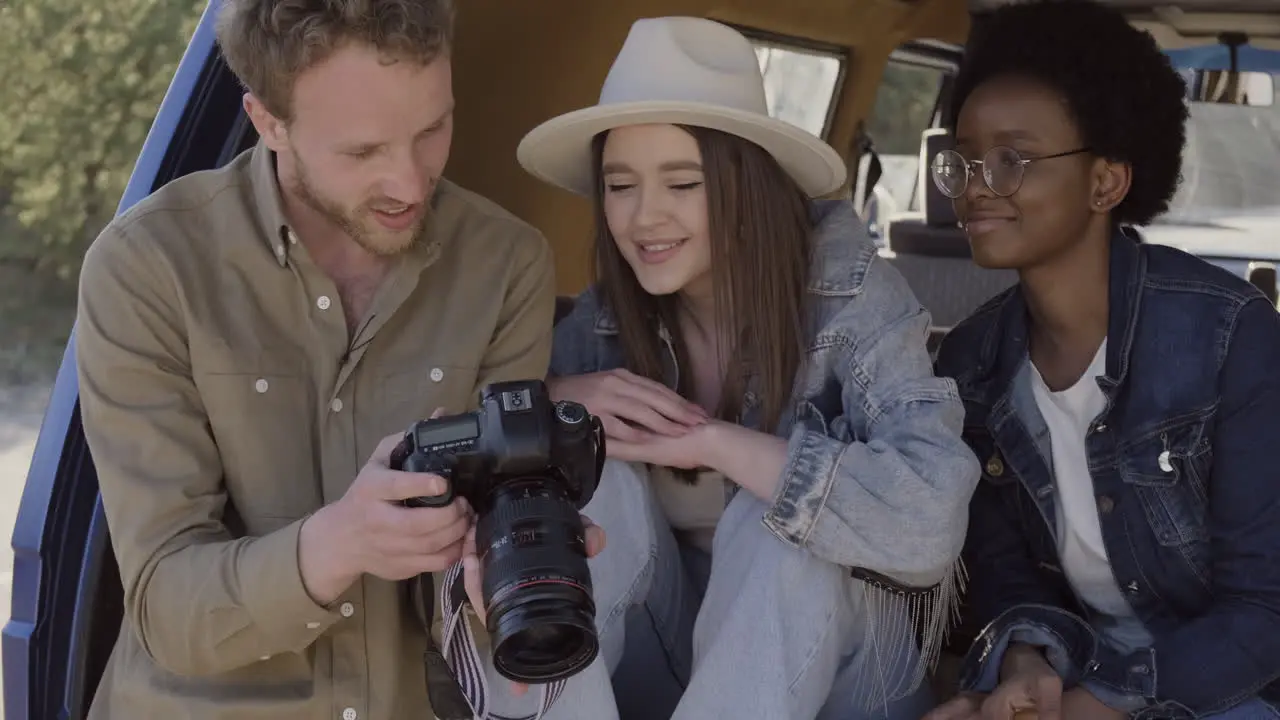 A Young Photographer Shows The Pictures He Has Taken To Two Beautiful Young Girls Inside The Caravan During A Roadtrip 2