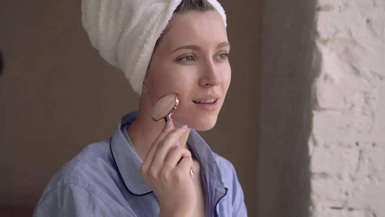 Portrait Of Woman Using Face Massager Roller Sculpting Tool