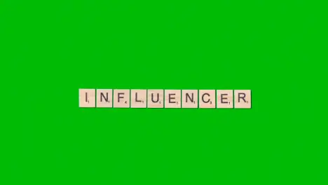 Stop Motion Business Concept Overhead Wooden Letter Tiles Forming Word Influencer On Green Screen 1