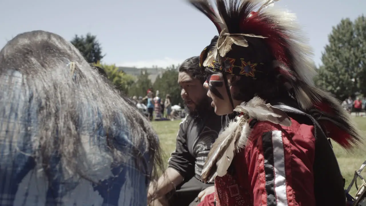 Indigenous men drumming in costume