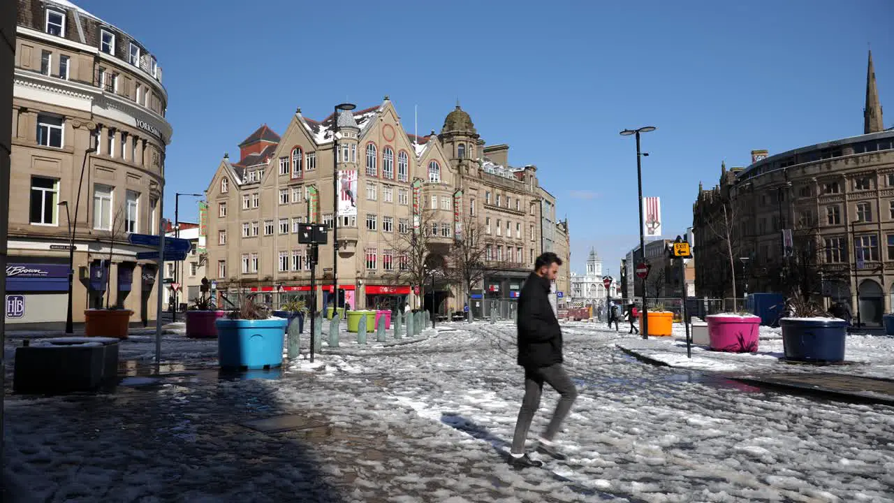 Melting snow and slush in Sheffield city centre on sunny day