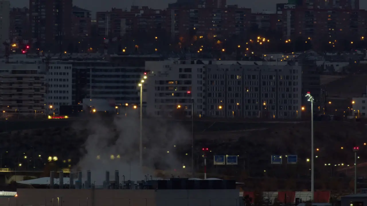 Evening Madrid view with apartment houses and working plant