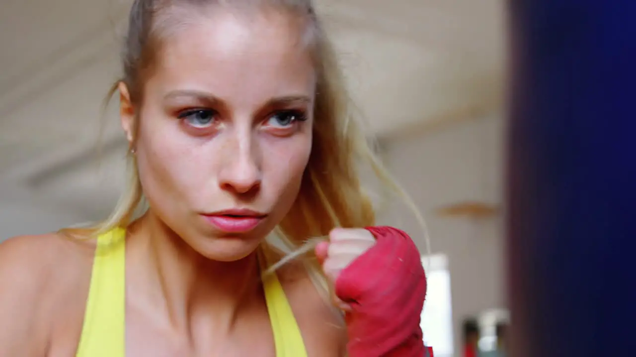 Female boxer practicing boxing in a boxing ring 4k