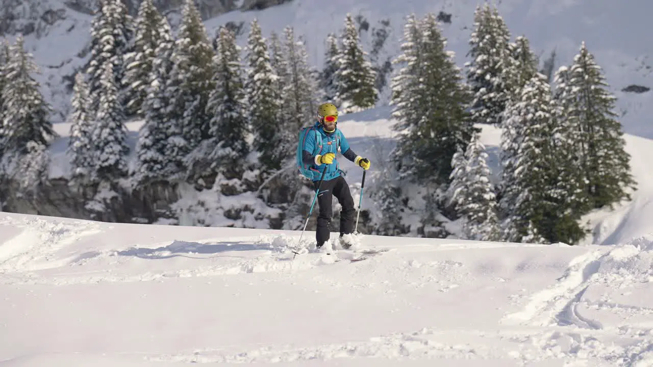 Slow motion of man skiing downhill and slaloming in snow slope