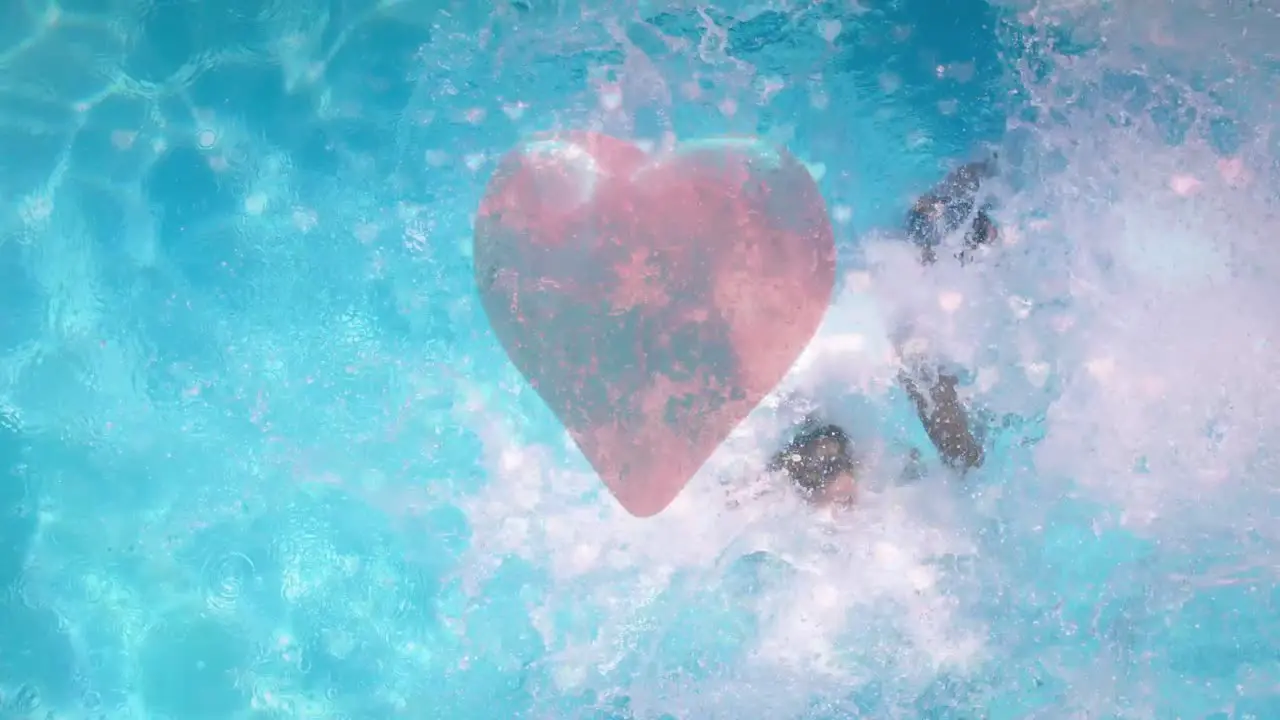 Man and woman jumping on swimming pool