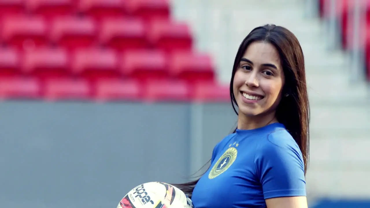 Cute Brazilian soccer fan girl flicks hair smiles at camera