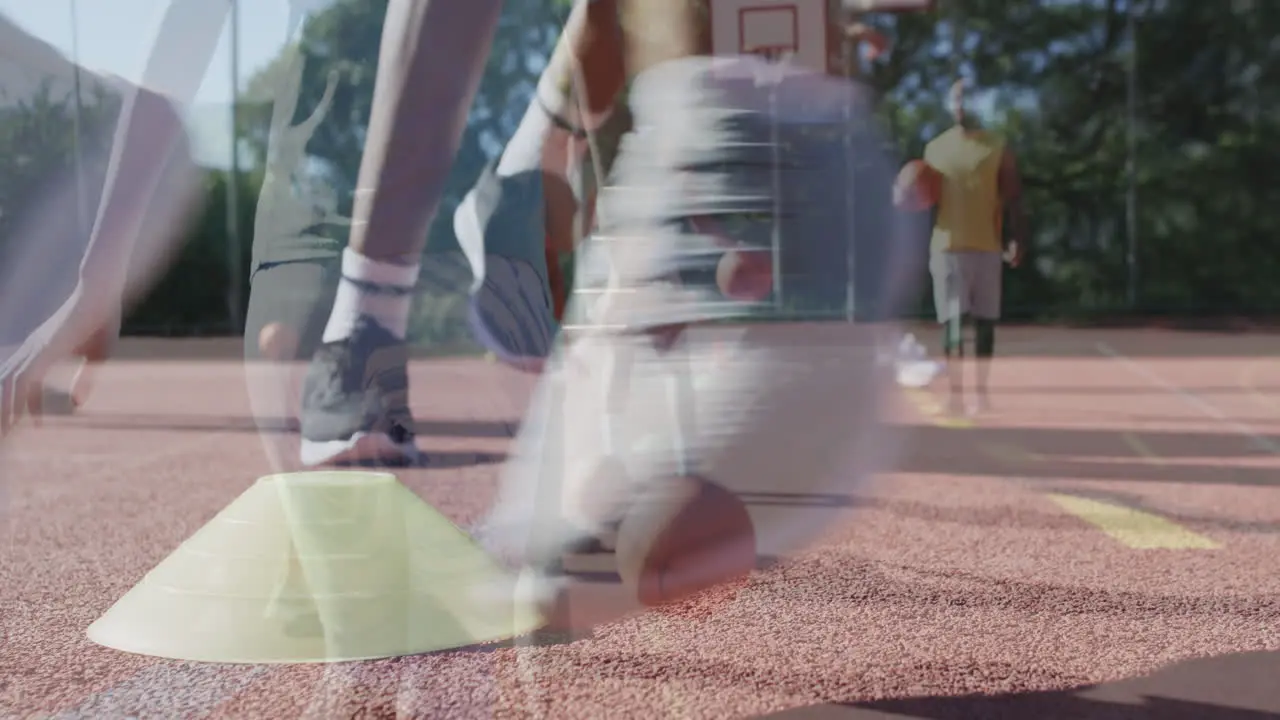 Diverse female basketball team training with male coach on court in slow motion