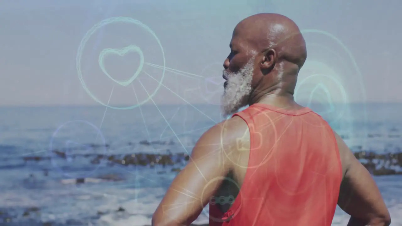 Animation of network of digital icons over african american senior man standing near the sea