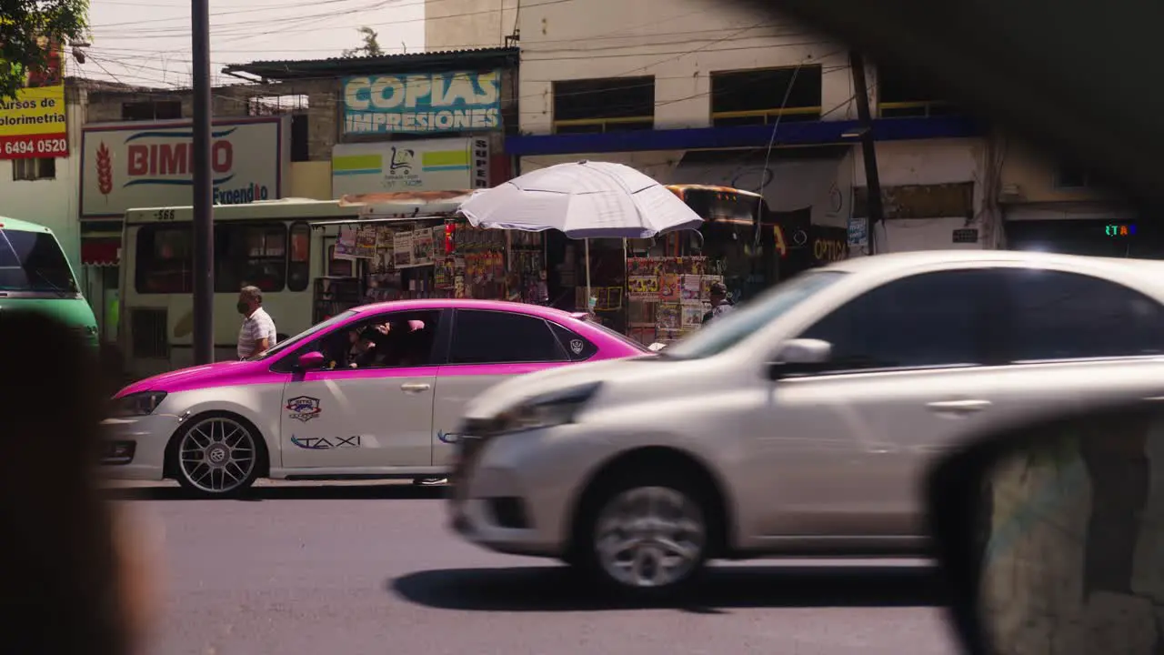 Cars driving in streets of suburbs of Mexico city handheld view