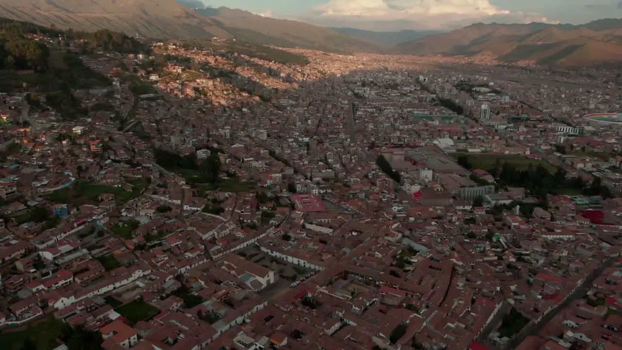 4k aerial drone panoramic view during the daytime before sunset of the central Cusco capital of the Inca with a zoom in over the Plaza de Armas