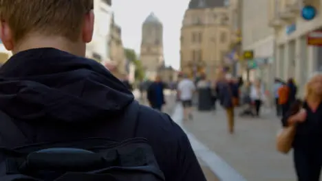 Over the Shoulder Shot of Man Walking Down Cornmarket Street In Oxford England