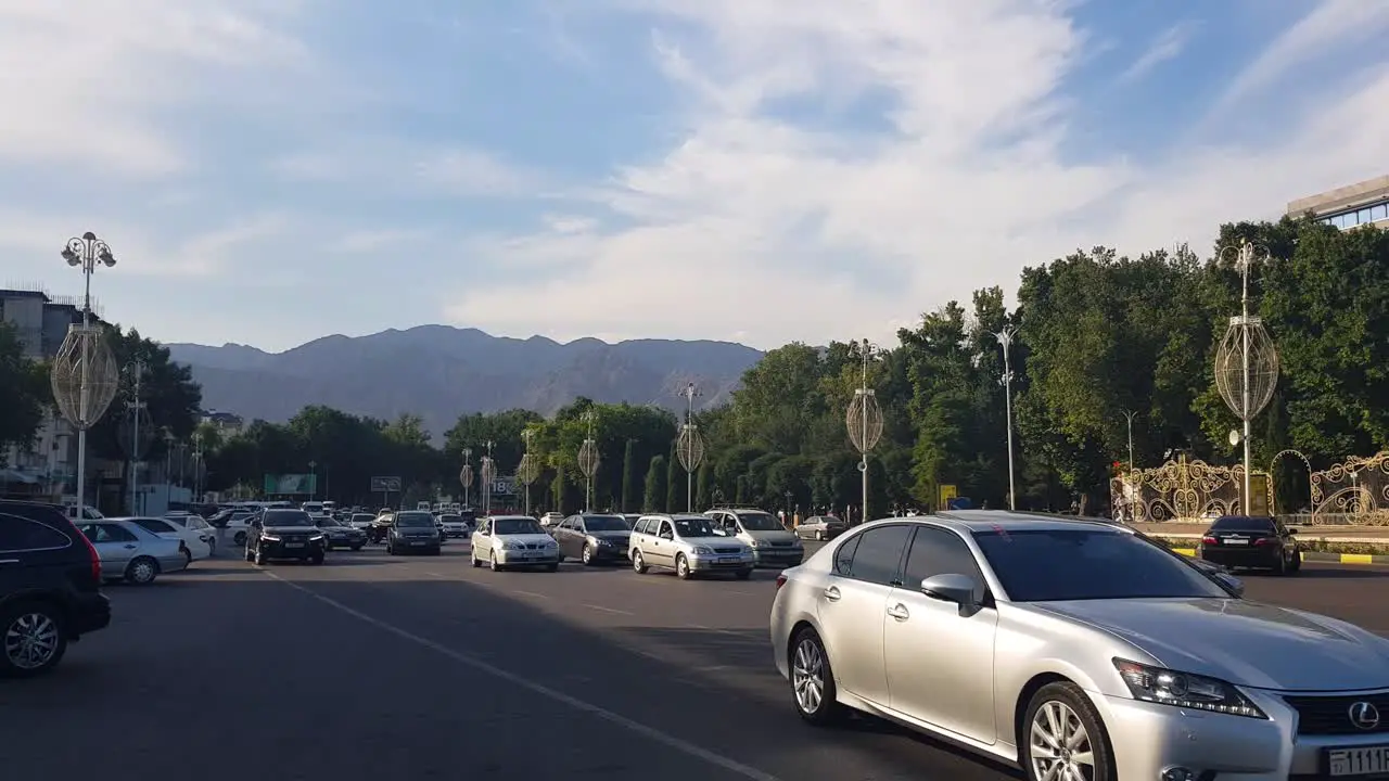 Busy Street Traffic in Downtown of Khujand Tajikistan on Sunny Evening Wide View