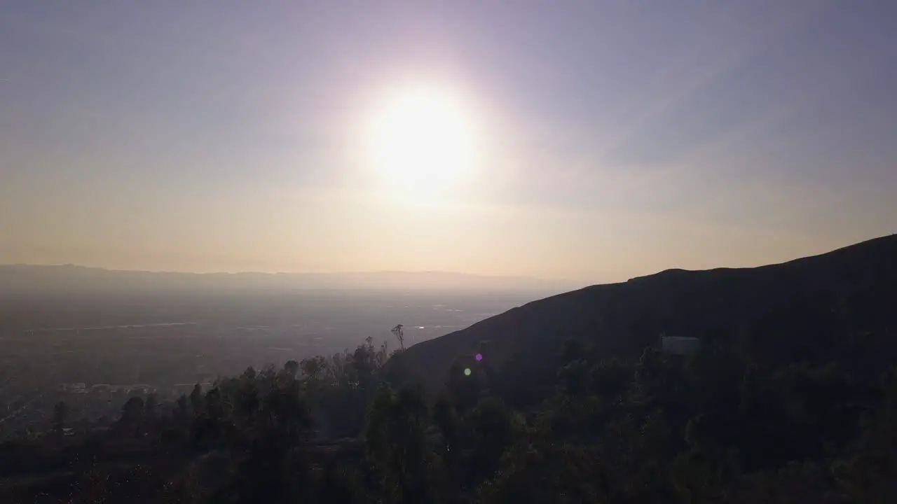 Aerial fly through trees to reveal San Fernando Valley Evening