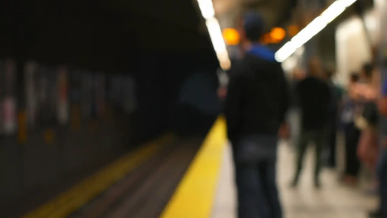 Commuters waiting for train on subway platform 4k