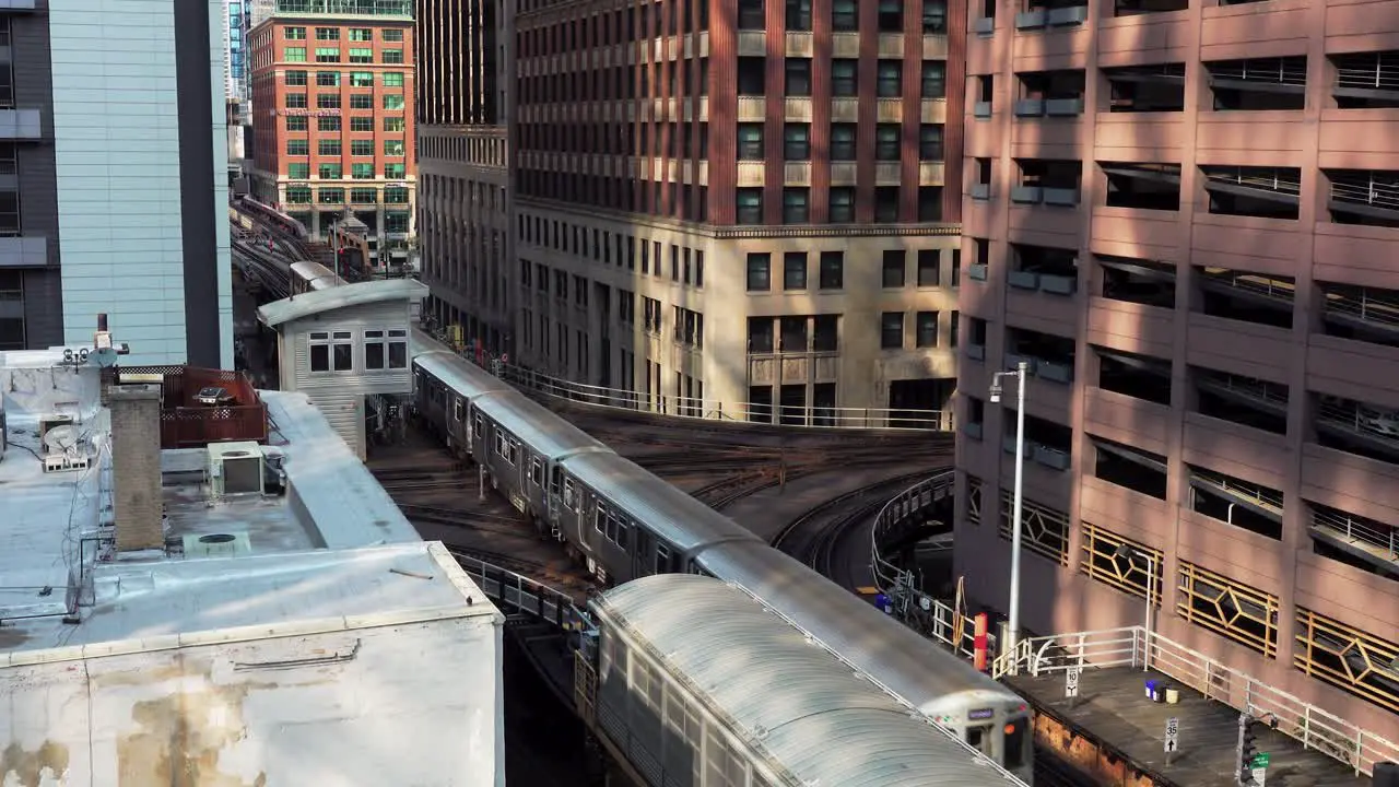 Subway Train Going Through A City Center With Tall Buildings Chicago