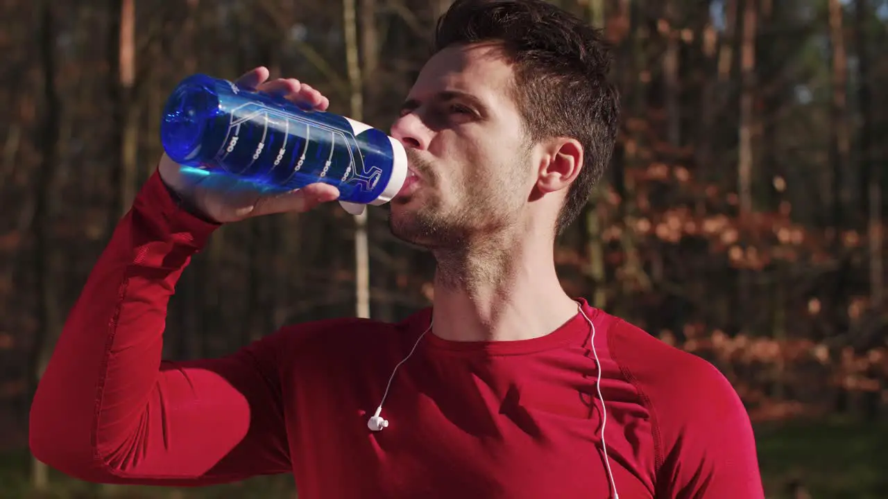 Close up of man drinking water after hard workout