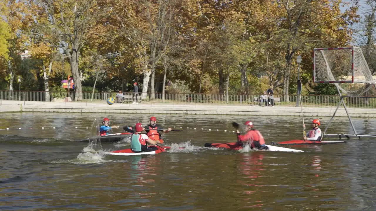 Group of young people practicing kayak pole or canoe pole on a lake in the park of casa de campo in Madrid