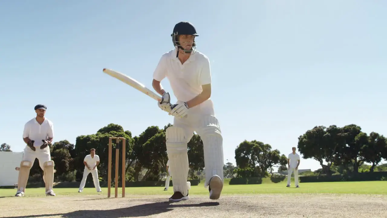 Batsman playing a defensive stroke during cricket match