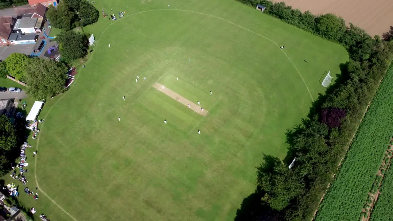 High altitude 4K drone footage of an English village cricket match