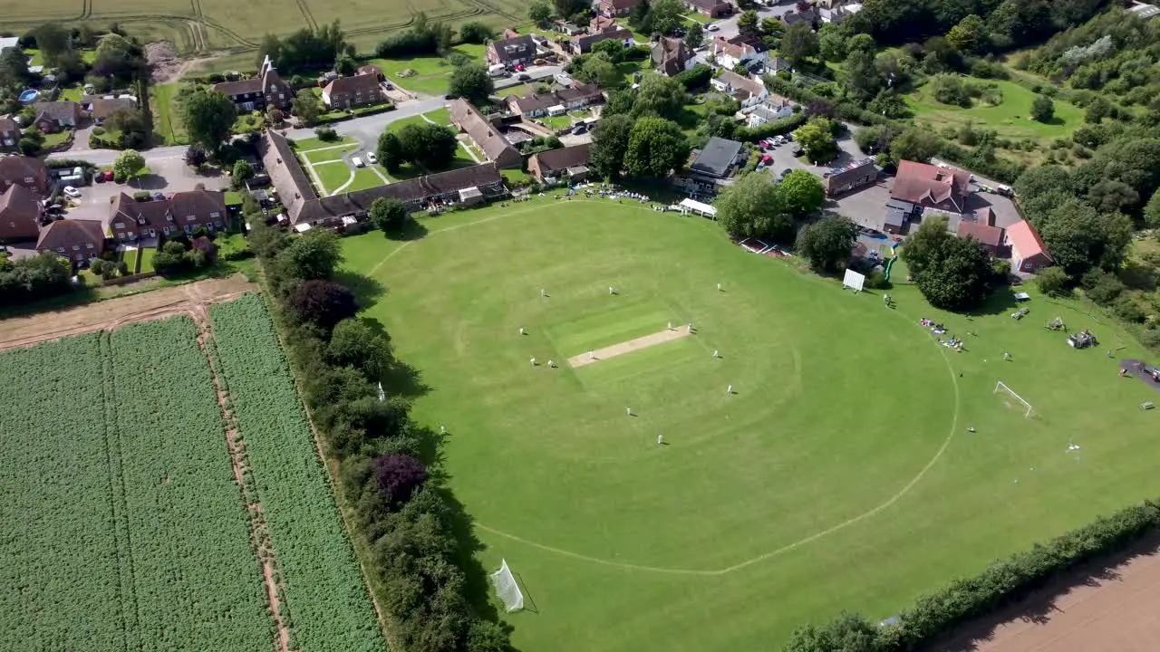 4K wide angle aerial video of a village cricket match in Kent England